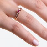 Gold rings with diamonds and rubies on models hand