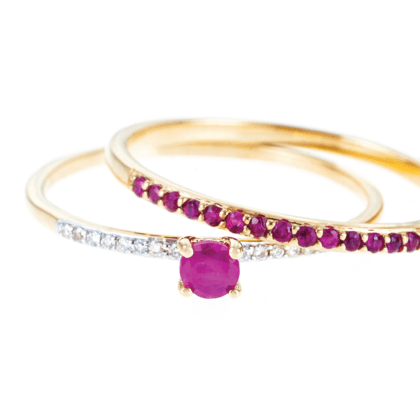 Gold rings with diamonds and rubies set of two rings on white background