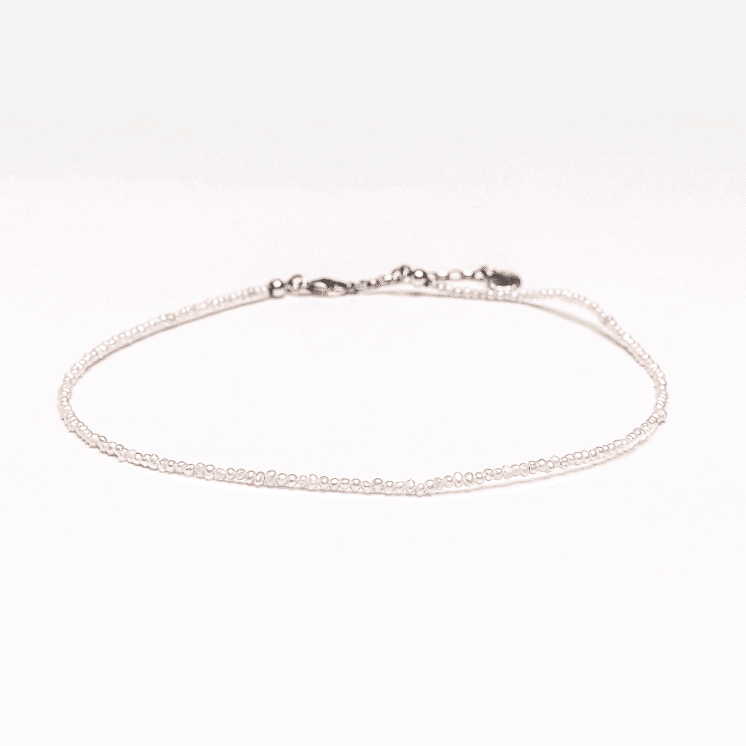 Pearls necklace choker with silver elements on white background