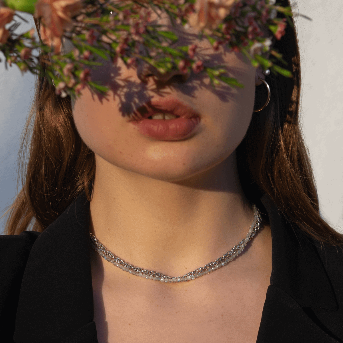 Gemstones necklace choker from labradorite with silver necklace on model.