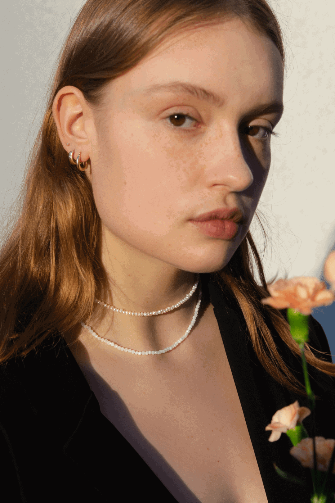 Gemstones necklaces and gold earring on model