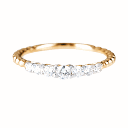 Gold ring with diamonds on white background