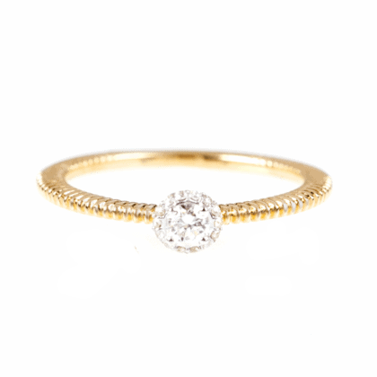 Gold ring with diamonds on white background