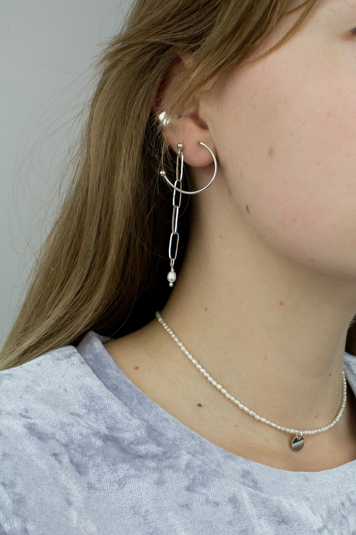 Silver semicircle earrings, silver ear cuff on the model