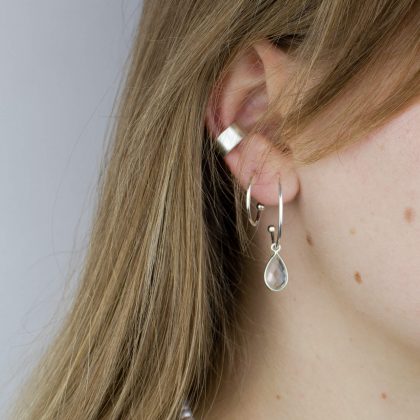 Earrings with crystal quartz and silver ear cuff on model