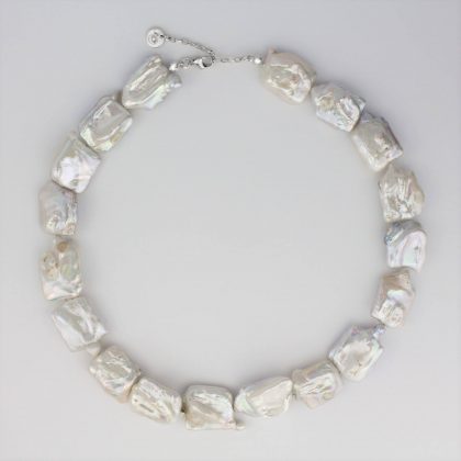 Baroque pearl necklace on grey background.