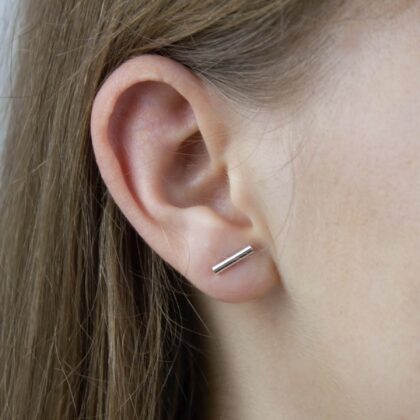 Silver line earrings on the model.