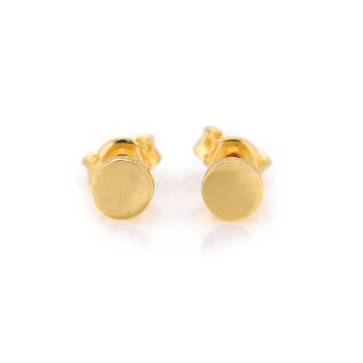 Delicate gold earrings on a light background