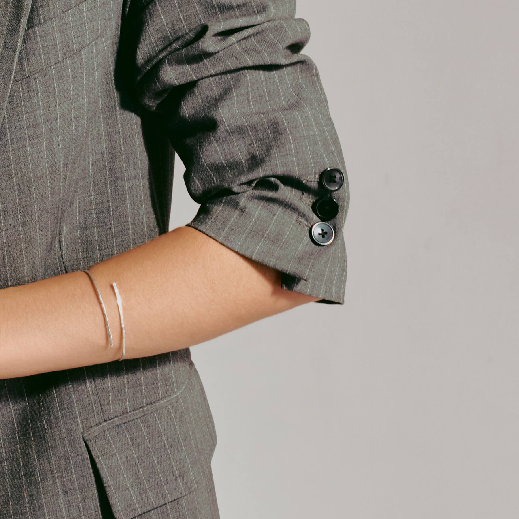 Rigid hammered silver bracelet on a model