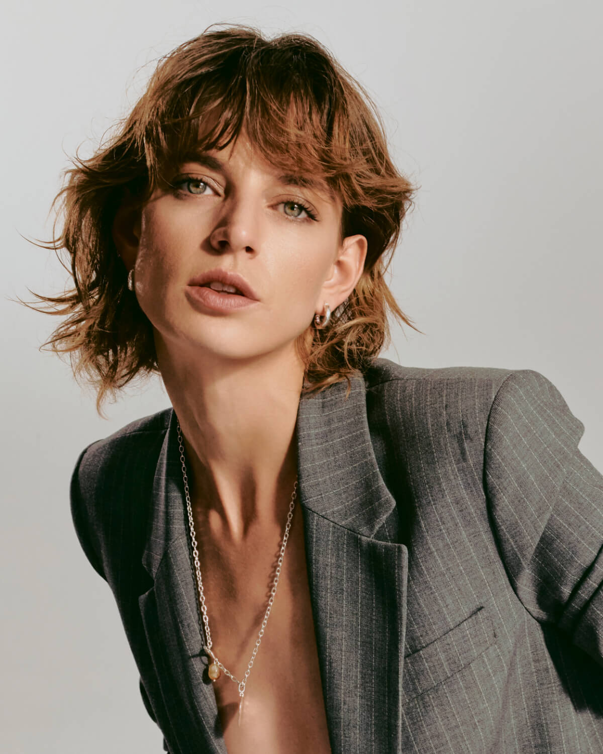 Classic silver hoops earrings and citrine necklace on model